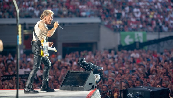 Ein Mann steht vor vielen Menschen in einem Stadion auf einer Bühne und singt. © NDR/Benjamin Hüllenkremer 