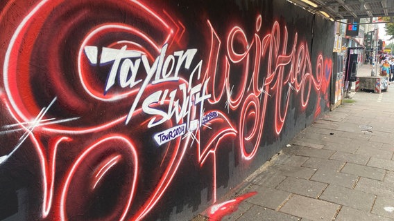 Ein großes Graffiti auf der Reeperbahn, auf dem steht Taylor Swift Tour 2024. © Katharina Preuth / NDR Foto: Katharina Preuth / NDR