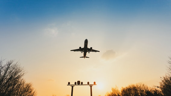 Ein Flugzeug startet in der Dämmerung. © MichaelJBerlin / photocase.de Foto: MichaelJBerlin / photocase.de