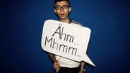 Ein Junge hält ein Schild hoch auf dem "Ähm...Mhmm" zu lesen ist. © Photocase Foto: Cydonna