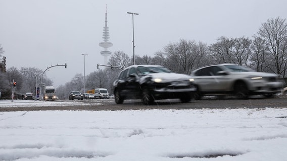 Fahrzeuge sind nach starkem Schneefall auf einer Hauptverkehrsstraße unterwegs © dpa-Bildfunk Foto: Christian Charisius