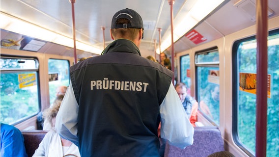 Ein Mitarbeiter der Hochbahn überprüft in Hamburg in einer U-Bahn die Fahrscheine von Reisenden. (Symbolbild) © Daniel Reinhardt/dpa Foto: Daniel Reinhardt