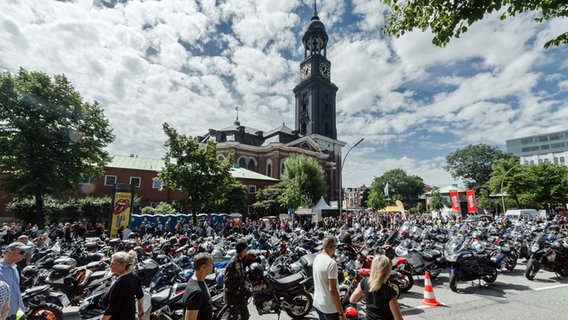 Motorräder und Fahrer, die am Motorradgottesdienst teilnehmen, stehen vor der Hauptkirche St. Michaelis in Hamburg. © picture-alliance / dpa Foto: Markus Scholz