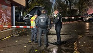 Drei Polizisten stehen an einem Unfallort in Hamburg. © NDR Foto: Elias Bartl