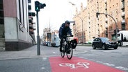 Ein Radfahrer fährt in Hamburg über einen Fahrradweg. © picture alliance / ABB 