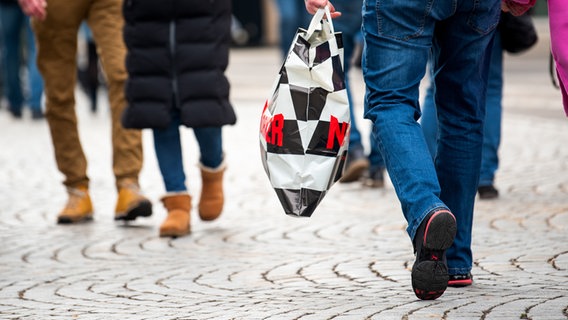 Eine Frau und ein Mann tragen mehrere Einkaufstüten am verkaufsoffenen Sonntag auf der Mönckebergstraße. © picture alliance/dpa Foto: Daniel Bockwoldt