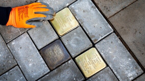 Zwei Stolpersteine für die NS-Opfer Auguste Friedburg (l) und Yves Saget werden im Stadtteil Rotherbaum vor ihrem früheren Wohnhaus an der Rothenbaumchaussee verlegt. © picture alliance/dpa Foto:  Daniel Bockwoldt