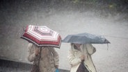 Zwei Menschen tragen Regenschirme © dpa-Bildfunk Foto: Daniel Reinhardt