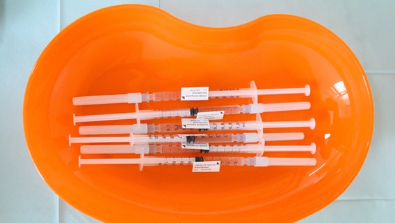 Spritzen mit dem Corona-Vakzin von Astrazeneca liegen während eines Pressetermins in einer Hausarztpraxis in einer Nierenschale. © dpa-Bildfunk 