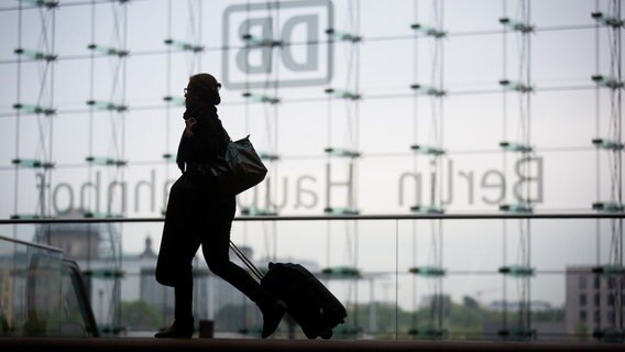 Eine Reisende zieht im Hauptbahnhof in Berlin ihren Koffer hinter sich her. © picture-alliance / dpa Foto: Kay Nietfeld