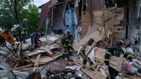 Rettungskräfte räumen die Trümmer eines durch einen russischen Luftangriff zerstörten Gebäudes. © Evgeniy Maloletka/AP 
