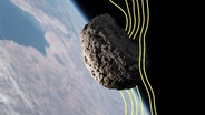 Ein Asteroid und im Hintergrund die Erde. © Imago 