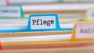 Ein Hängeregister mit der Aufschrift "Pflege". © picture alliance Foto: Zerbor