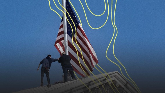 Arbeiter passen die US-Flagge auf dem Kapitol an. © picture alliance Foto: Nicolas Economou