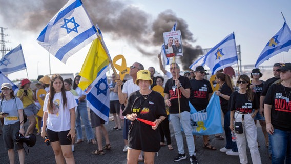 Angehörige, Freunde und Unterstützer der von der Hamas im Gazastreifen entführten israelischen Geiseln nehmen an einem Protest auf der israelischen Küstenstraße außerhalb des Kibbuz Yakum teil. © dpa Foto: Ilia Yefimovich