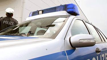 Symbolbild Polizei, Wagen und Uniformierter © dpa 