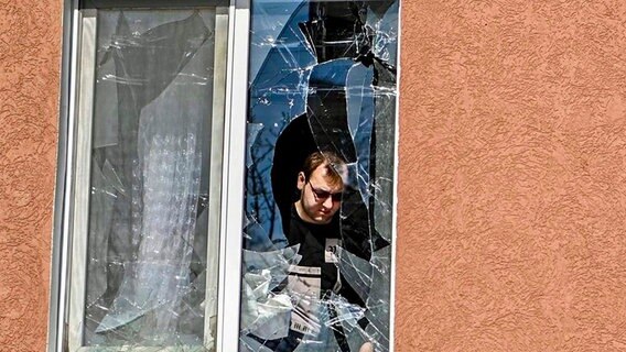 Ein Mann betrachtet das zerbrochene Fenster seines Hauses nach dem Beschuss durch die Ukraine © dpa Bildfunk Foto: Uncredited/Belgorod region governor Vyacheslav Gladkov telegram channel/AP/dpa