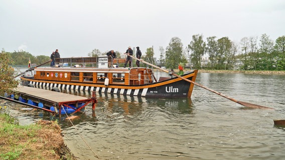 Menschen in einem Holzboot mit der Aufschrift Ulm, eine sogenannte Ulmer Schachtel © NDR Foto: Rita Knobel-Ulrich