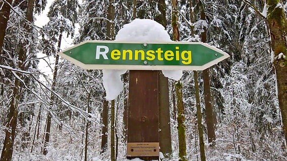 ein Schild mit der Aufschrift Rennsteig im verschneiten Wald in Thüringen © NDR Foto: Jörg Wunram