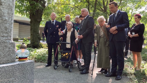 31.07.2024, Polen, Warschau: Wanda Traczyk-Stawska, Teilnehmerin des Warschauer Aufstands 1944, zeigt Bundespräsident Frank-Walter Steinmeier einen Gedenkstein auf dem Friedhof für die toten Aufständischen. Als Zeichen der Erinnerung an deutsche Verbrechen im Zweiten Weltkrieg nahm der Bundespräsident am Gedenken an den Warschauer Aufstand vor 80 Jahren teil. © dpa Foto: Friedemann Kohler