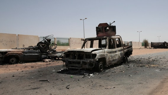 Zerstörte Militärfahrzeuge stehen nach anhaltender Kämpfe auf einer Straße in Khartum. © Marwan Ali/AP/dpa Foto: Marwan Ali