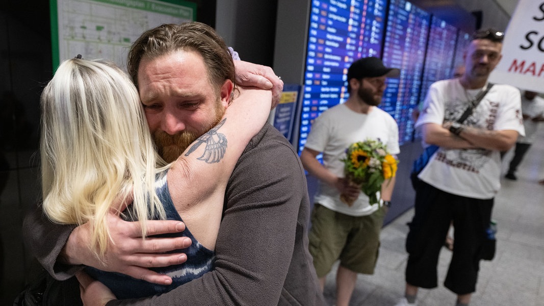 Patrick K. wird nach seiner Landung auf dem Flughafen in Frankfurt von seiner Mutter umarmt.