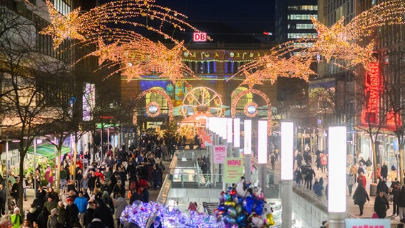 Passanten laufen durch die weihnachtlich geschmückte Innenstadt vor dem Hauptbahnhof in Hannover © picture alliance/dpa Foto: Julian Stratenschulte