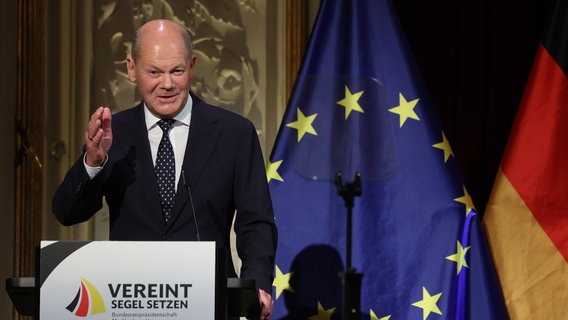 Bundeskanzler Olaf Scholz (SPD) spricht auf dem Festakt im Mecklenburgischen Staatstheater. © dpa Foto: Jens Büttner