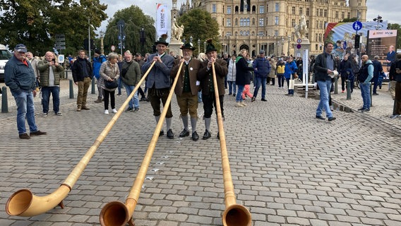 Alphornbläser aus Bayern bei der Einheitsfeier 2024 vor dem Schweriner Schloss. © NDR Foto: Jakob Gaberle