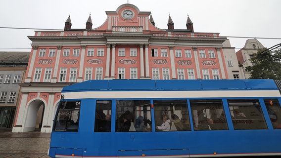 Eine Straßenbahn fährt am Rostocker Rathaus vorbei. © dpa picture alliance Foto: Bernd Wüstneck