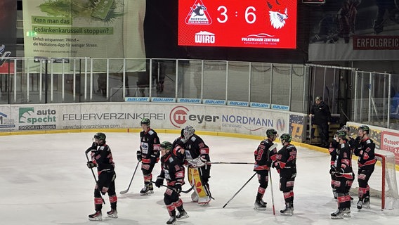 Nach der 3:6 Niederlage gegen die Füchse Berlin stehen die Spieler der Rostock Piranhas zusammen auf dem Eis © NDR Foto: Axel Krummenauer