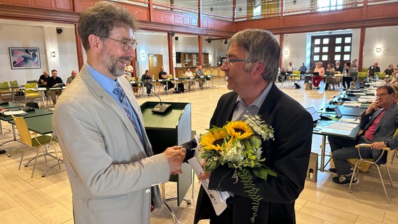 Güstrows Bürgermeister Schuldt gratuliert Andreas Ohm zur erneuten Wiederwahl als Präsident der Stadtvertretung © NDR Foto: Axel Krummenauer