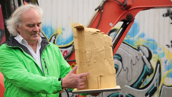 Ein Mann hält das Modell einer Kletterwand in den Händen. © Hansesatdt Stralsund Pressestelle 