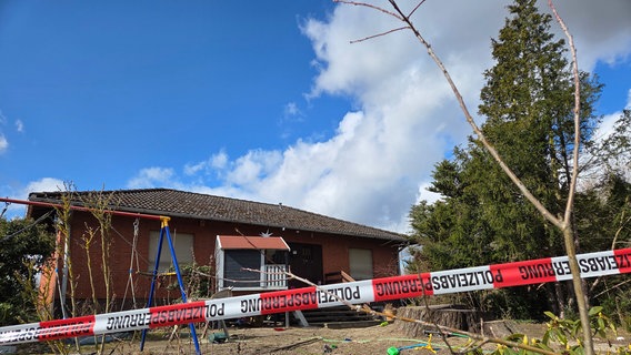 Ein Wohnhaus in  ist mit Flatterband der Polizei abgesperrt. © dpa-Bildfunk Foto: Christian Brahmann/dpa