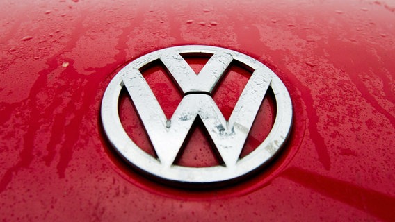 Regentropfen perlen über das VW-Logo auf einer roten Motorhaube. © dpa-Bildfunk Foto: Julian Stratenschulte