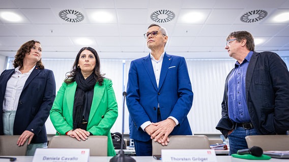 Daniela Cavallo (Mitte li), Gesamt- und Konzernbetriebsratsvorsitzende der Volkswagen AG, und Thorsten Gröger (Mitte re), Bezirksleiter der IG Metall in Niedersachsen und Sachsen-Anhalt, nehmen an der zweiten Runde der Tarifverhandlungen von Volkswagen und IG Metall teil. © Moritz Frankenberg/dpa Foto: Moritz Frankenberg/dpa