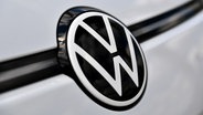 Das VW Logo ist in der Front eines Autos zu sehen. © picture alliance/dpa Foto: Hendrik Schmidt