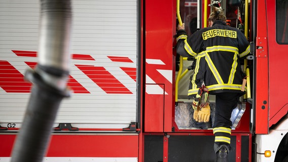 Eine Frau steigt in ein Feuerwehrauto. © picture alliance/dpa Foto: Sebastian Gollnow