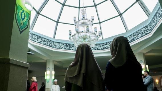 Zwei muslimische Frauen mit Kopftüchern stehen am Tag der offenen Moschee in der Ayasofya-Moschee in Hannover nebeneinander. © picture alliance / dpa | Peter Steffen Foto: Peter Steffen