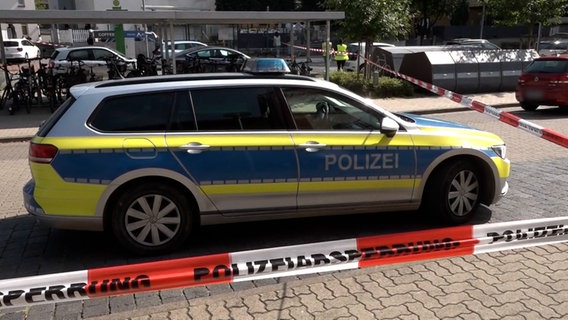 Ein Polizeiauto steht hinter Absperrband am Tatort in Sarstedt. © NonstopNews Aktuell 