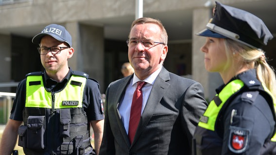 Minister Pistorius (SPD) steht mit zwei Polizeibeamten zusammen. © Niedersächsisches Ministerium für Inneres und Sport 