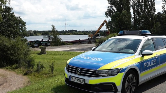 Ein Polizeiauto vor einem Baggersee in Weyhe (Landkreis Diepholz). © Nord-West-Media TV 