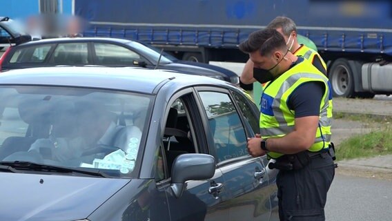 Zwei Bundespolizisten kontrollieren einen Autofahrer. 