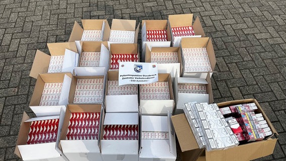 Auf dem Boden stehen mehrere Kartons mit 500 Stangen Zigaretten ohne Steuermarken darauf. © Polizeiinspektion Osnabrück 