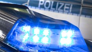 Ein Blaulicht auf einem Polizeiwagen, im Hintergrund ein weiterer Polizeiwagen. © picture alliance/dpa Foto:  Friso Gentsch