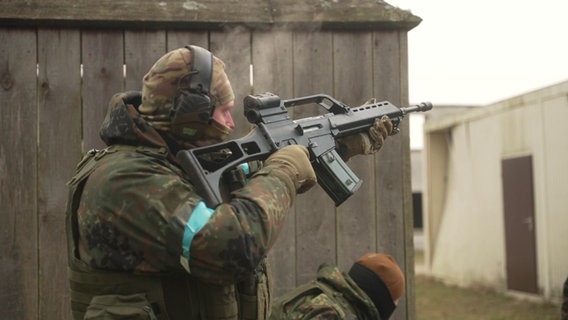 Der ukrainische Soldat Dmytrol sichert eine Hausecke auf einem Truppenübungsplatz der Bundeswehr. © NDR 