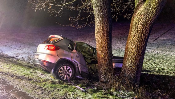 Ein stark deformiertes Auto steht seitlich an einem Baum. © Kreisfeuerwehr Gifhorn Foto: Torben Niehs