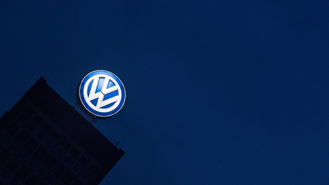 Das Logo des VW-Konzerns leuchtet am Verwaltungshochhaus.