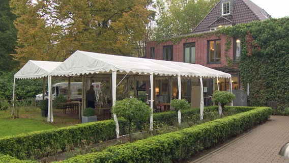 Pavilions are set up in front of an old people's home  