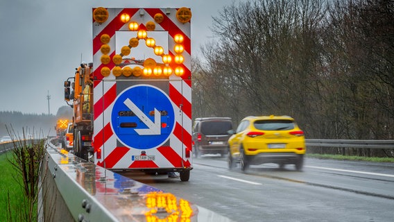 Warnhinweis Spurwechsel an einem Fahrzeug der Autobahnmeisterei auf der Autobahn A4 bei Regen © picture alliance / imageBROKER Foto: Matthias Graben